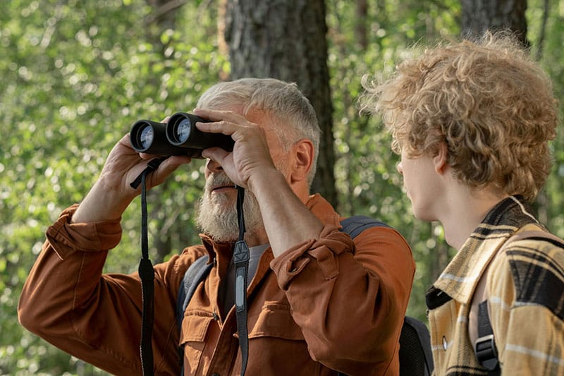 Man And Boy Bird Watching