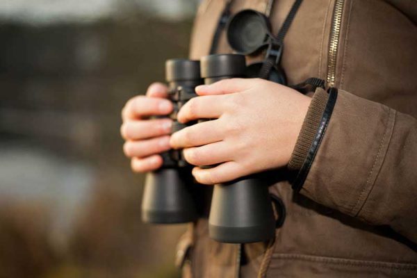 Man Holding Binoculars